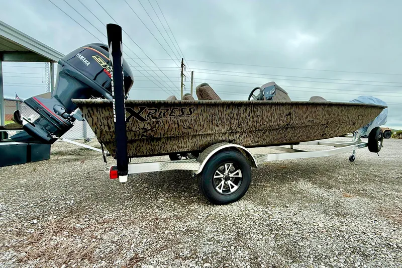 The Image of 2027 Express XP200 Catfish boat with Yamaha engine on trailer, parked outdoors. - 1