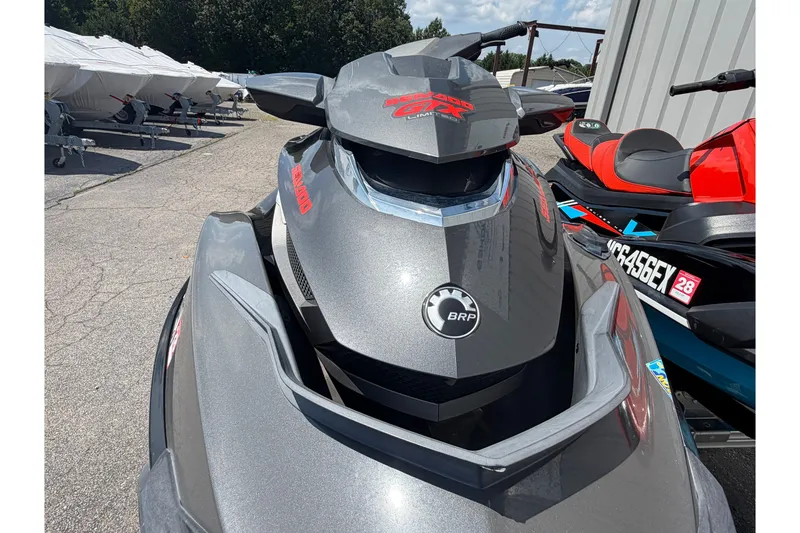 Slide: The Image of 2014 Sea-Doo GTX Limited iS 260 jet ski in a parking area, showcasing sleek design. - 2