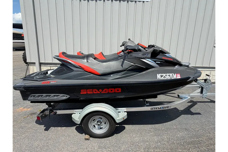 The Image of 2014 Sea-Doo GTX Limited iS 260 jet ski on trailer, parked outdoors. - 0