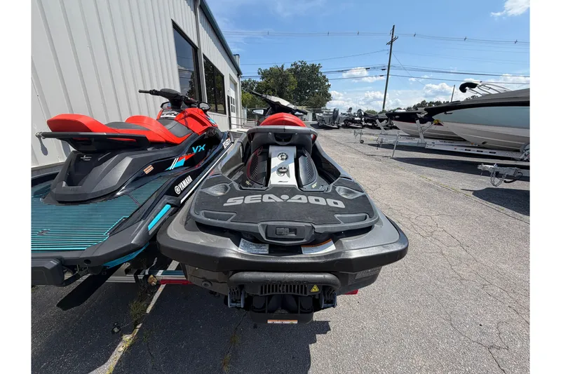 Slide: The Image of 2014 Sea-Doo GTX Limited iS 260 jet ski parked beside Yamaha VX, outdoor display. - 3