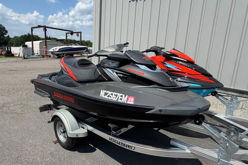 Slide: The Image of 2014 Sea-Doo GTX Limited iS 260 jet ski on trailer, parked outdoors. - 1