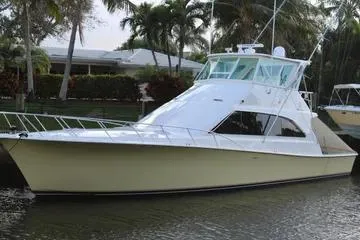 Slide: The Image of 1996 Ocean 53 Super Sport yacht docked near palm trees. - 2