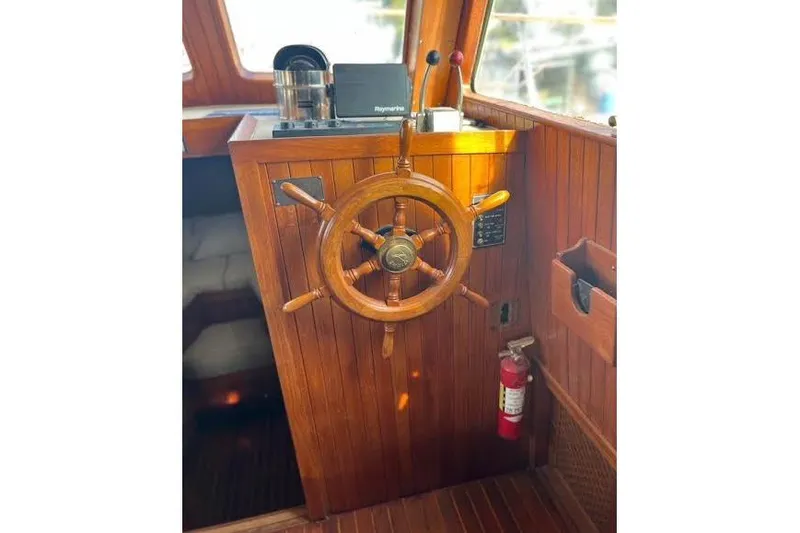 Slide: The Image of Wooden helm of 1987 Monk 36 Trawler with navigation equipment and fire extinguisher. - 8