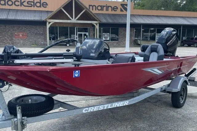 Slide: The Image of Red 2020 Crestliner 1700 Storm boat on trailer, parked outside marine store. - 6