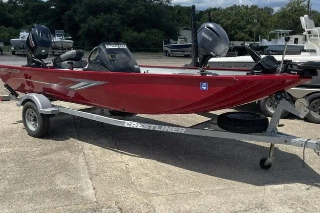 Slide: The Image of 2020 Crestliner 1700 Storm boat on trailer, red exterior, parked outdoors. - 7