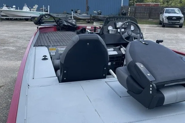 Slide: The Image of 2020 Crestliner 1700 Storm boat interior with seating and steering wheel in a parking area. - 4