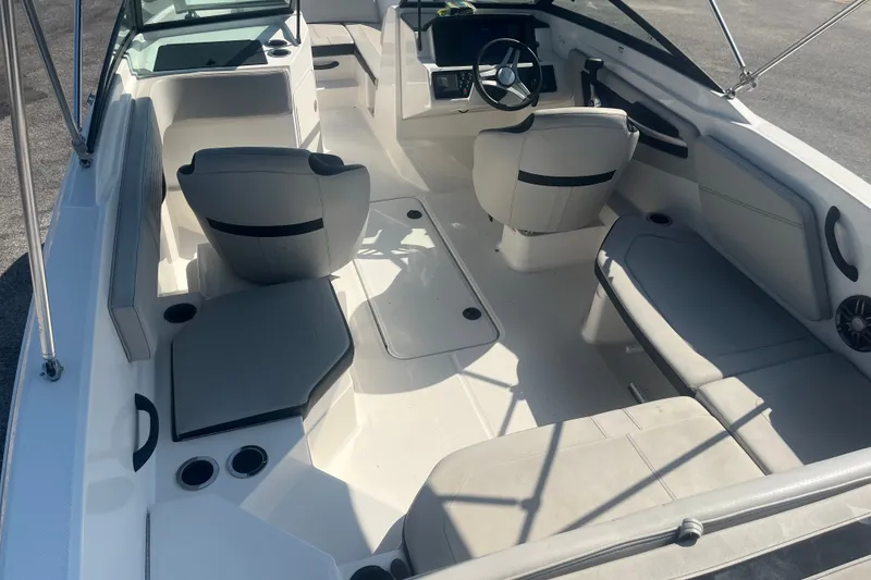Slide: The Image of 2023 Sea Ray SPX 210 Outboard boat interior with seating and steering wheel. - 8