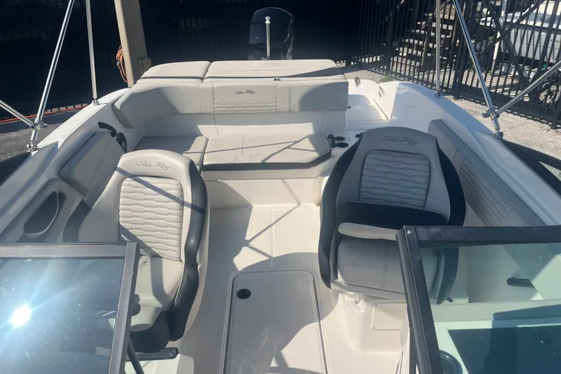Slide: The Image of 2023 Sea Ray SPX 210 Outboard interior with seating and steering wheel. - 4