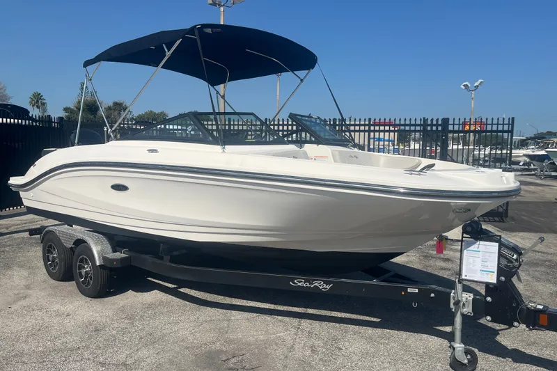 Slide: The Image of 2023 Sea Ray SPX 210 Outboard boat on trailer, featuring sleek design and black canopy. - 12