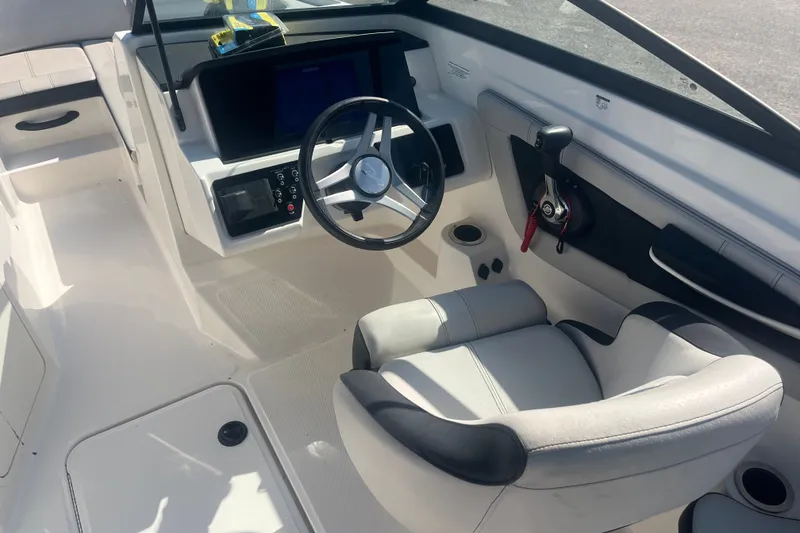 Slide: The Image of 2023 Sea Ray SPX 210 Outboard boat cockpit with steering wheel and controls. - 7