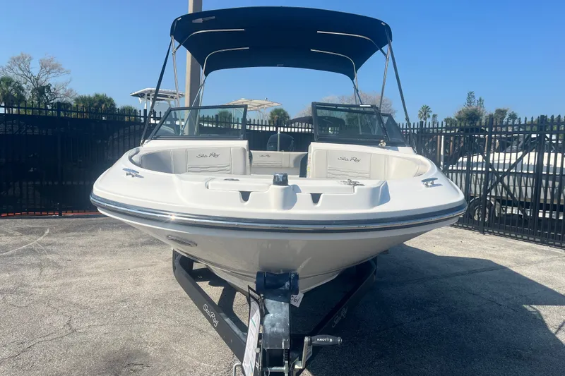 Slide: The Image of 2023 Sea Ray SPX 210 Outboard boat on trailer, parked outdoors. - 13