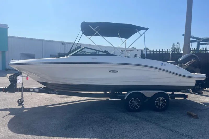 Slide: The Image of 2023 Sea Ray SPX 210 Outboard boat on trailer, parked outdoors. - 15