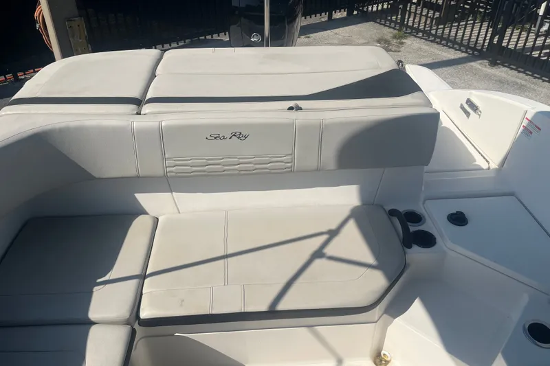 Slide: The Image of 2023 Sea Ray SPX 210 Outboard boat interior with cushioned seating. - 2