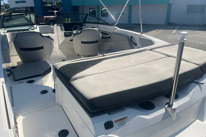Slide: The Image of 2023 Sea Ray SPX 210 Outboard boat interior with seating and steering wheel. - 9