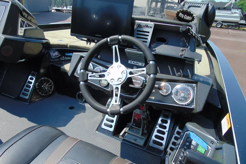 Slide: The Image of 2016 Ranger Z521L boat dashboard with steering wheel, gauges, and electronic controls. - 6
