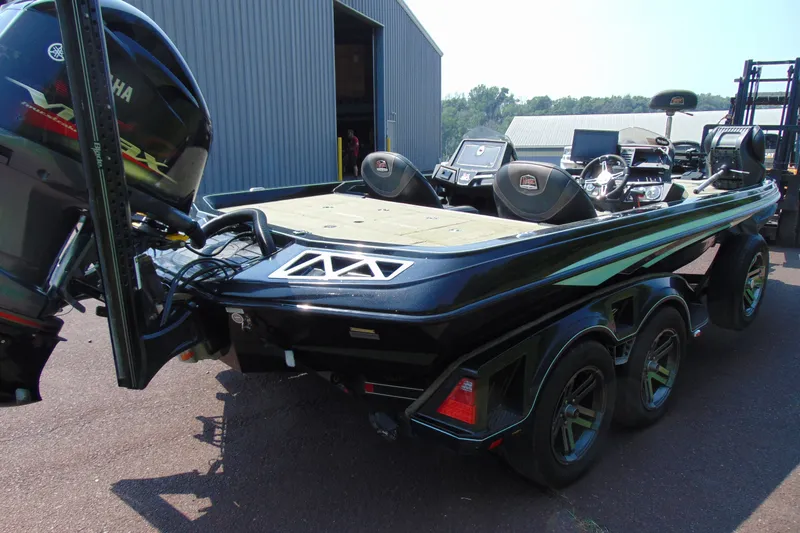 Slide: The Image of 2016 Ranger Z521L boat with Yamaha engine, parked near a warehouse. - 5