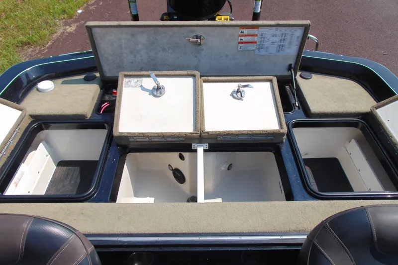Slide: The Image of 2016 Ranger Z521L boat storage compartments with open lids, showcasing interior space. - 11
