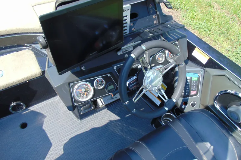 Slide: The Image of 2016 Ranger Z521L boat dashboard with steering wheel, gauges, and Garmin display. - 10