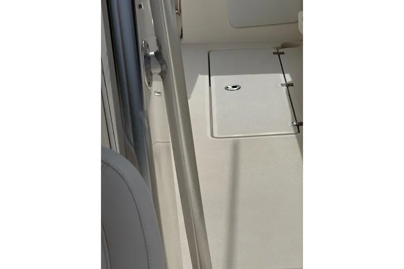 Slide: The Image of Interior view of a 2013 Sea Fox 286 Center Console boat, featuring a hatch and seating area. - 33
