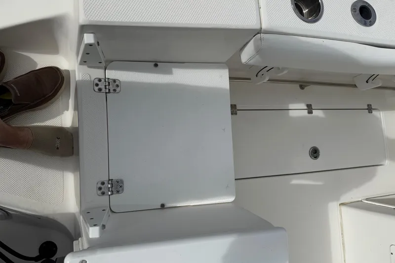 Slide: The Image of 2013 Sea Fox 286 Center Console deck with storage hatch and shoes visible. - 15