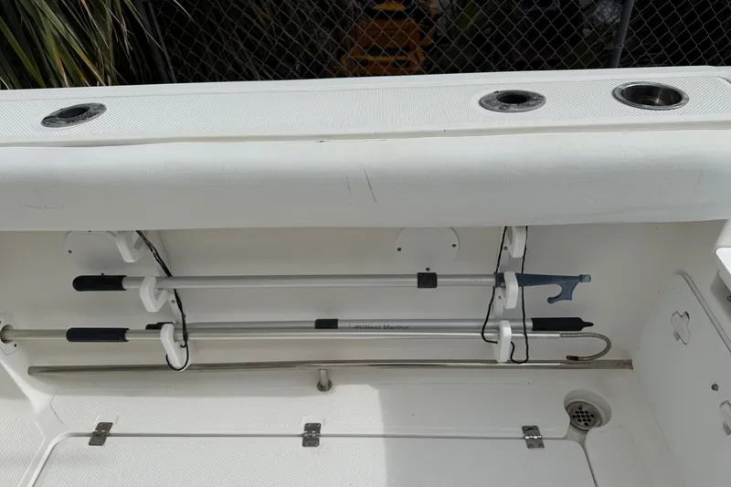 Slide: The Image of 2013 Sea Fox 286 Center Console boat interior with rod holders and storage compartment. - 24