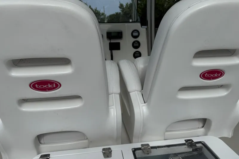 Slide: The Image of White seats on a 2013 Sea Fox 286 Center Console boat, featuring Todd branding. - 13