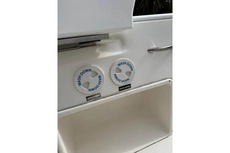 Slide: The Image of 2013 Sea Fox 286 Center Console washdown controls and storage compartment. - 23