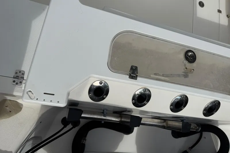 Slide: The Image of 2013 Sea Fox 286 Center Console boat interior with rod holders and storage compartment. - 14