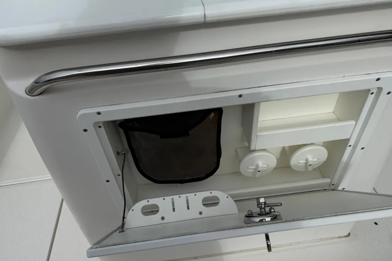 Slide: The Image of 2013 Sea Fox 286 Center Console storage compartment with open hatch and stainless steel handle. - 19