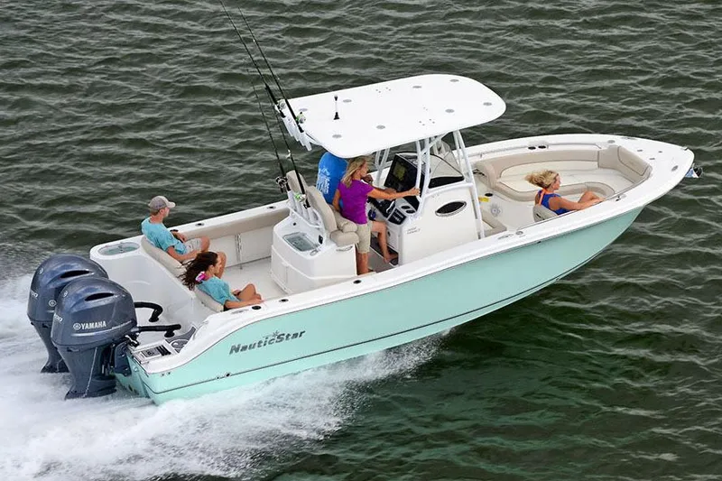 Slide: The Image of Manufacturer Provided Image: 2018 NauticStar 2602 Legacy boat cruising with passengers on open water. - 0