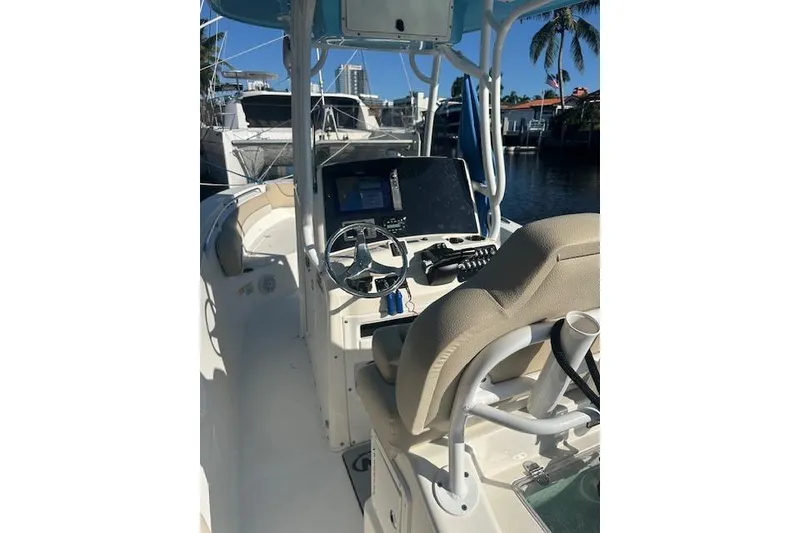 Slide: The Image of 2018 NauticStar 2602 Legacy boat interior with steering wheel and navigation equipment. - 29