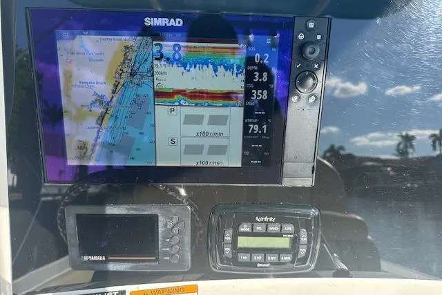 Slide: The Image of Simrad navigation system on 2018 NauticStar 2602 Legacy boat dashboard. - 26