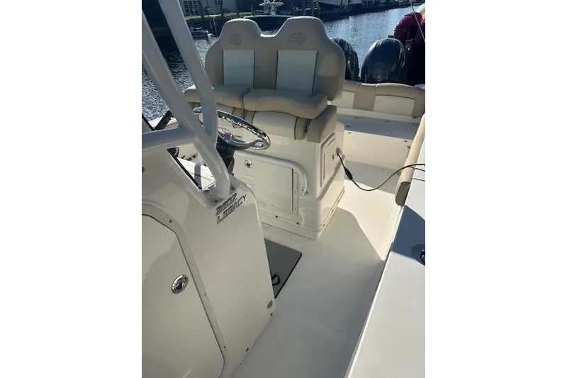 Slide: The Image of 2018 NauticStar 2602 Legacy boat interior with helm and seating. - 21