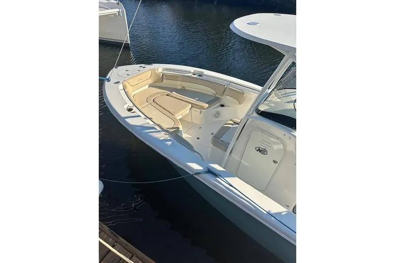 Slide: The Image of 2018 NauticStar 2602 Legacy boat docked on calm water. - 4