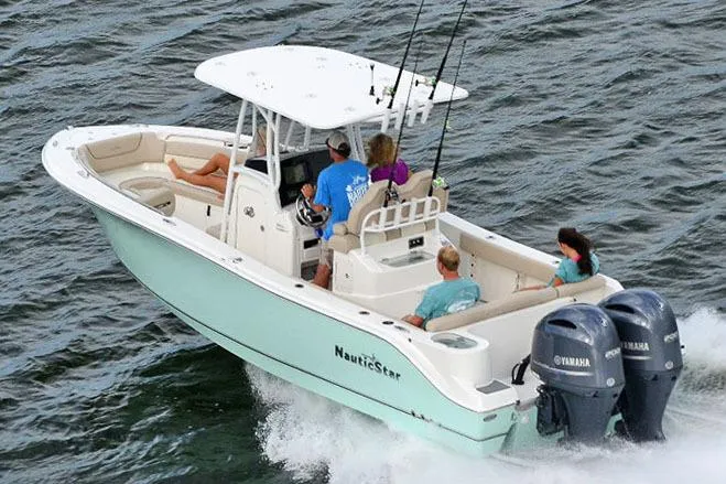 Slide: The Image of Manufacturer Provided Image: 2018 NauticStar 2602 Legacy boat cruising with passengers on the water. - 12