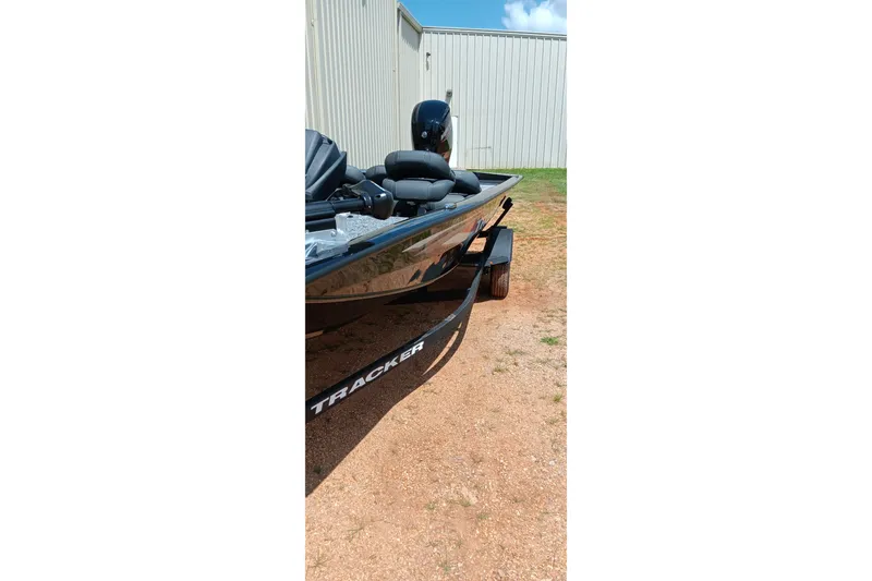 Slide: The Image of 2027 Tracker Pro Team 175 boat on trailer, parked outdoors near a building. - 13