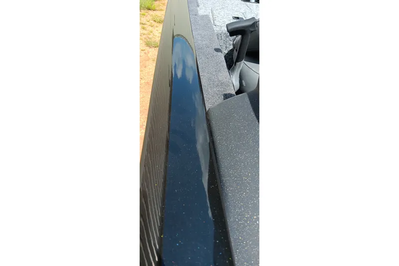 Slide: The Image of 2027 Tracker Pro Team 175 boat with sleek, reflective black surface detail. - 16