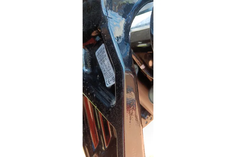 Slide: The Image of Close-up of a 2027 Tracker Pro Team 175 label on a black surface. - 17