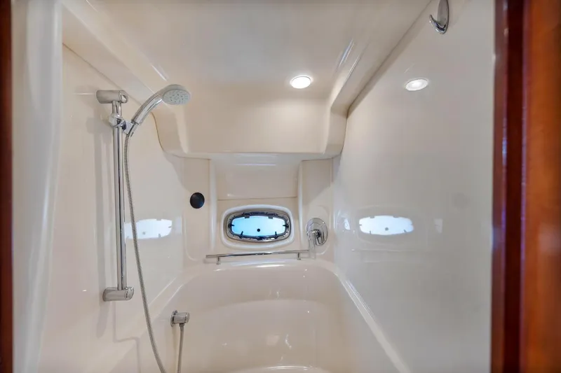 Slide: The Image of Shower area in 2007 Sea Ray 48 Sundancer yacht with porthole and modern fixtures. - 16