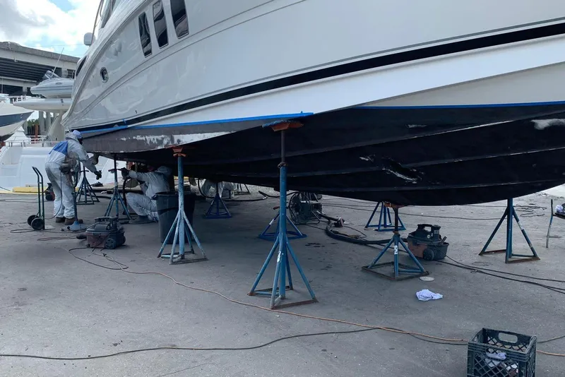Slide: The Image of Workers repairing 2007 Sea Ray 48 Sundancer yacht hull on stands. - 19