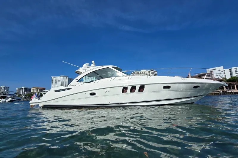 The Image of 2007 Sea Ray 48 Sundancer yacht on water with city skyline background. - 0