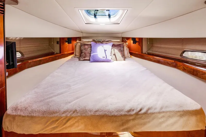 Slide: The Image of Luxurious bedroom interior of 2007 Sea Ray 48 Sundancer yacht with skylight and plush bedding. - 13