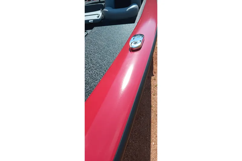 Slide: The Image of Red exterior detail of 2027 Tracker Pro Team 175 boat with metal fixture. - 13