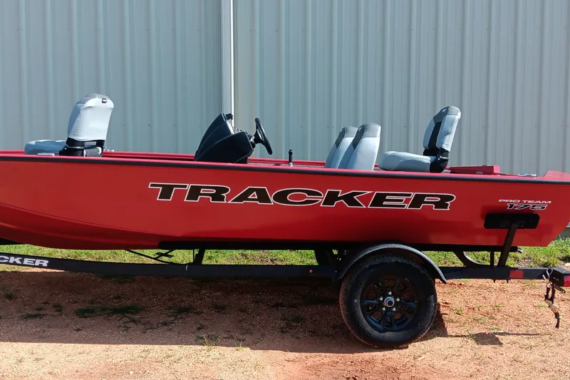 The Image of Red 2027 Tracker Pro Team 175 boat on trailer, parked outdoors. - 0