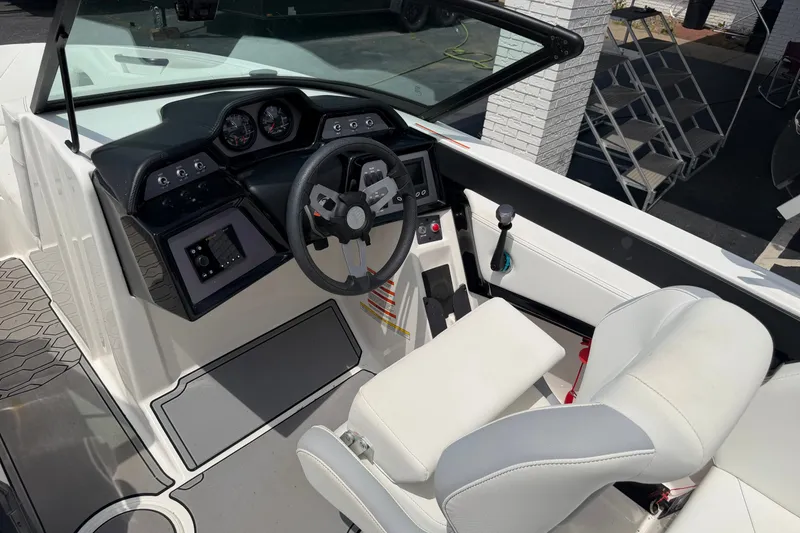 Slide: The Image of 2022 MasterCraft NXT20 boat cockpit with steering wheel and dashboard controls. - 7