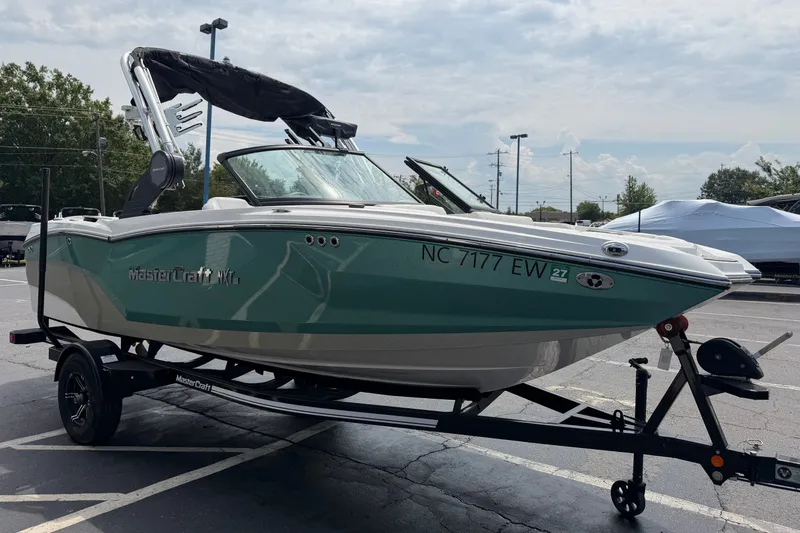 Slide: The Image of 2022 MasterCraft NXT20 boat on trailer in parking lot, side view. - 4
