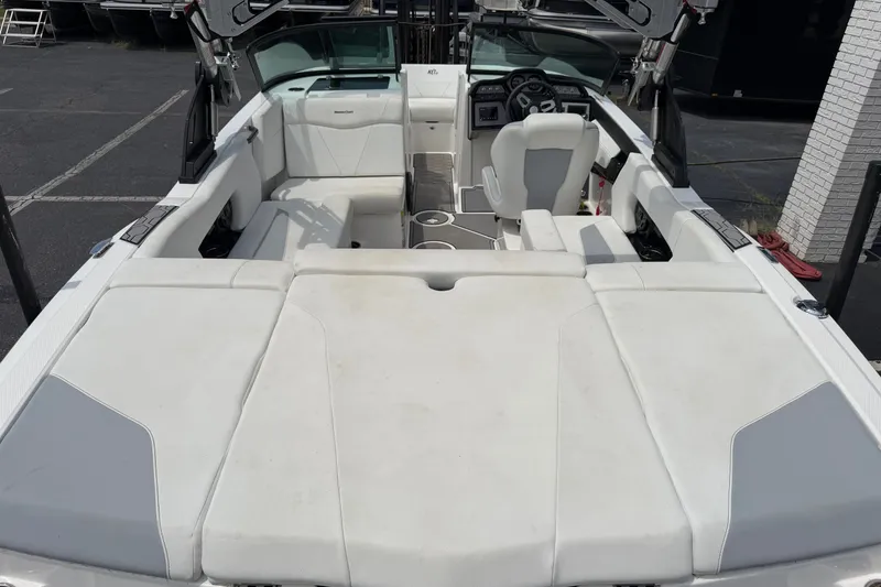 Slide: The Image of 2022 MasterCraft NXT20 boat interior with white seating and modern dashboard. - 5