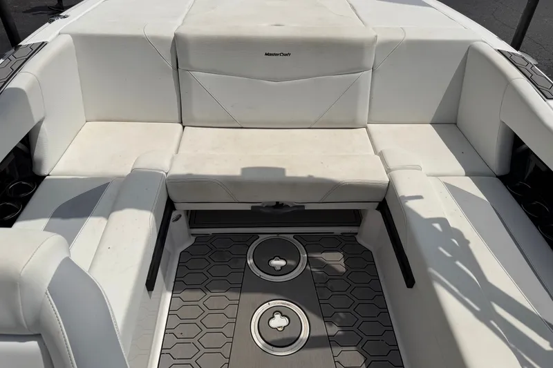 Slide: The Image of 2022 MasterCraft NXT20 boat interior with white seating and hexagonal floor design. - 9