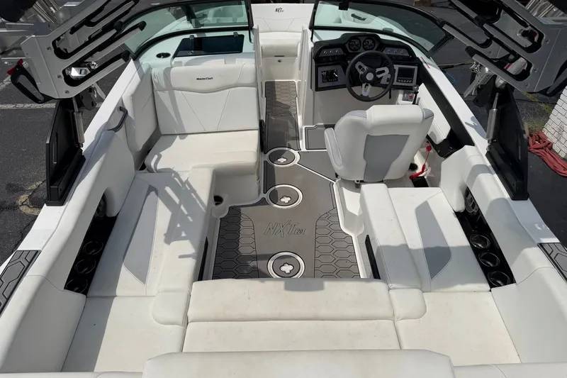 Slide: The Image of 2022 MasterCraft NXT20 boat interior with white seating and modern dashboard design. - 6