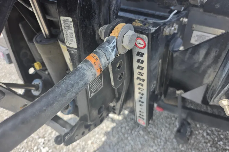 Slide: The Image of Close-up of a 2023 Nitro Z21 XL boat component with hydraulic hose and Bob's Machine logo. - 14